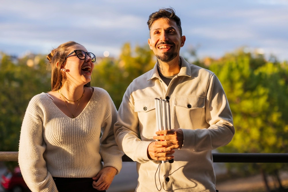 disabled men walking with caretaker in a park